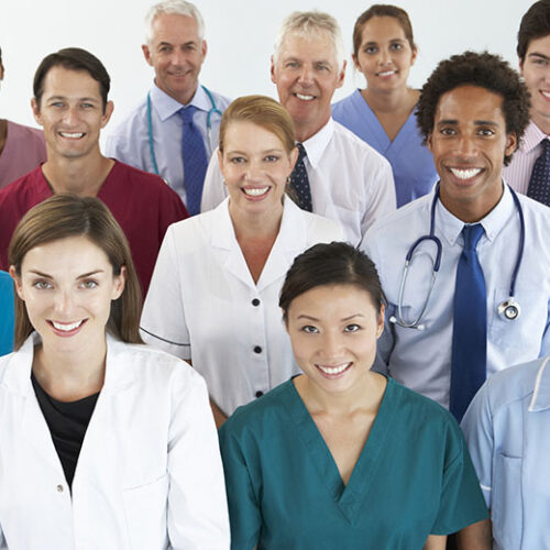 Portrait Of Group Of Workers In Medical Professions Smiling To Camera.